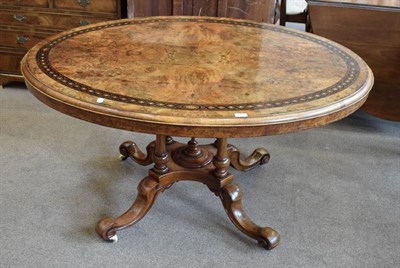 Lot 469 - A Victorian Figured Walnut and Marquetry Banded Oval Breakfast Table, circa 1870, the top decorated