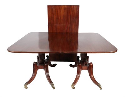 Lot 472 - A Regency Period Mahogany Twin-Pillar Dining Table, early 19th century, in three sections with...