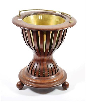 Lot 491 - A Mahogany and Brass Strung Planter, 20th century, of circular form with pivoting brass handle...