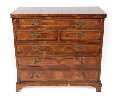 Lot 501 - ~ A Walnut and Featherbanded Bachelor's Chest, modern, in George II style, the hinged top above...