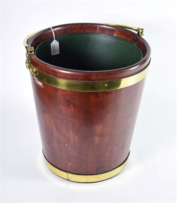 Lot 525 - ~ A George III Style Brass Bound Peat Bucket, modern, with pivoting handle and a green metal...