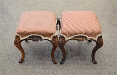 Lot 556 - A Pair of Victorian Carved Mahogany Dressing Stools, circa 1870, recovered in red and gold...