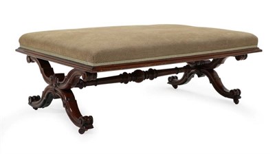 Lot 560 - ~ A Victorian Carved Walnut Footstool, circa 1870, recovered in brown fabric with an...