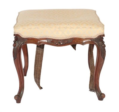 Lot 562 - ~ A Victorian Carved Walnut Dressing Stool, late 19th century, recovered in cream and blue...