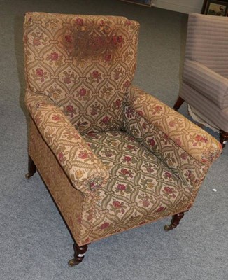 Lot 579 - A Victorian Armchair, late 19th century covered in green and floral geometric patterned fabric, the