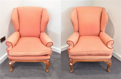 Lot 582 - A Pair of Queen Anne Style Wing-Back Armchairs, early 20th century, covered in faded pink...