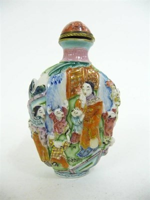 Lot 305 - A Chinese Porcelain Snuff Bottle and Stopper, 19th century, moulded in relief with mothers and...