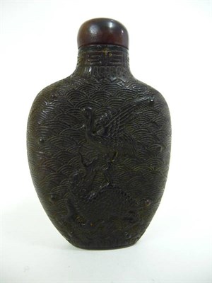 Lot 316 - A Chinese Horn Snuff Bottle, late 19th century, carved with a dragon and crane on a wave...