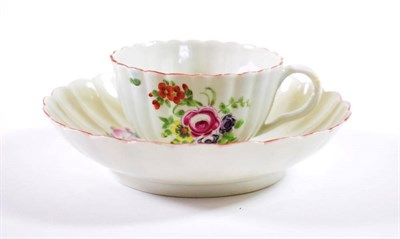 Lot 1199 - A Worcester Porcelain Tea Cup and Saucer, circa 1770, of fluted form, painted with flowersprays