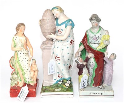 Lot 1245 - A Staffordshire Pearlware Figure Group of CHARITY, circa 1820, as a mother and children on a titled