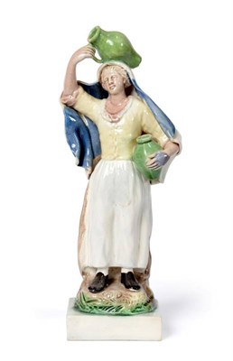 Lot 1247 - A Ralph Wood Type Pearlware Figure of a Girl, circa 1780, standing holding a ewer on her head...