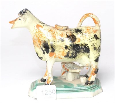 Lot 1250 - A Staffordshire Pearlware Cow Creamer, circa 1820, with sponged markings, a milkmaid to one...