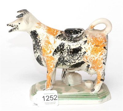 Lot 1252 - A Pearlware Cow Creamer, circa 1820, with black and ochre sponged markings, a milkmaid to one side