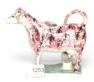 Lot 1253 - A Pearlware Cow Creamer, circa 1820, with black and manganese sponged decoration, a milkmaid to one