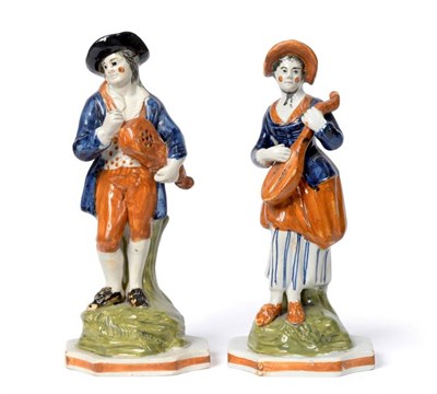 Lot 1255 - A Pair of Pratt Type Pearlware Figures of Rustic Musicians, circa 1800, he with a hurdy-gurdy,...