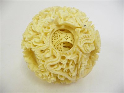 Lot 325 - A Chinese Carved and Pierced Ivory Puzzle Ball, circa 1960, the external skin carved with...