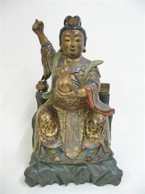 Lot 327 - A Chinese Carved Hardwood Painted and Gilt Figure in Ming Style, wearing flowing robes, his...