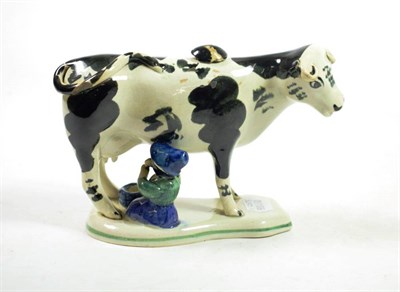 Lot 1310 - A Pearlware Cow Creamer and Stopper, mid 19th century, the standing beast with black markings,...