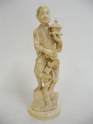 Lot 330 - A Japanese Carved Ivory Okimono, Meiji Period (1868-1912), as a gardener holding a pair of...