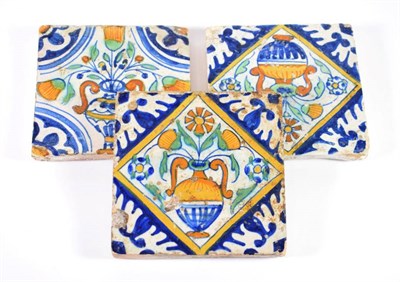 Lot 1314 - A Pair of Delft Tiles, mid 17th century, in colours with vases of flowers within blue...