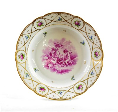 Lot 1345 - ~ A Nyon Style Porcelain Charger, late 19th century, painted in puce monochrome with cherubs...