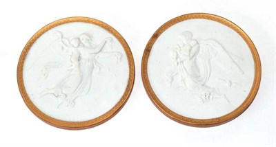 Lot 1347 - ~ A Pair of Royal Copenhagen Bisque Roundels, late 19th century, modelled as winged classical...