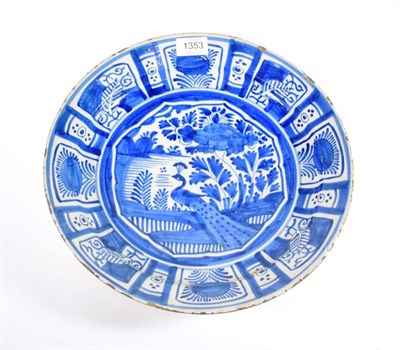 Lot 1353 - A Delft Saucer Dish, late 17th century, painted in Kraak style in blue with a peacock and landscape