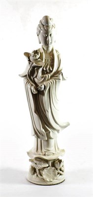 Lot 1397 - A Chinese Blanc de Chine Figure of Guanyin, Qing Dynasty, standing wearing flowing robes...