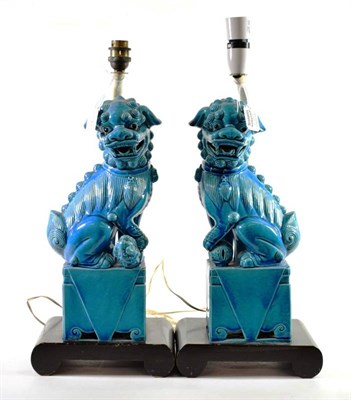 Lot 1398 - A Pair of Chinese Turquoise Glazed Porcelain Dogs of Fo, in Kangxi style, of traditional form...