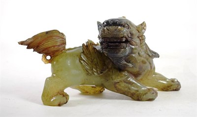 Lot 1410 - A Chinese Jade Lion Dog, in Ming style, standing roaring, 27cm long