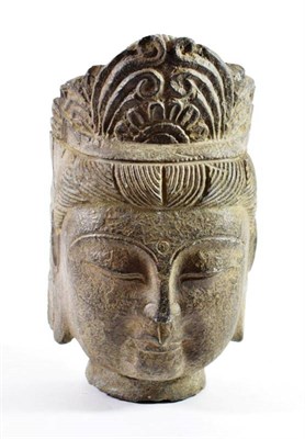 Lot 1412 - A Chinese Carved Stone Head of Buddha, in archaic style, with foliate head dress, 26cm high