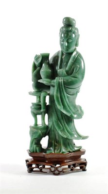 Lot 1420 - A Chinese Green Aventurine Figure of Guanyin, carved standing wearing flowing robes holding a vase