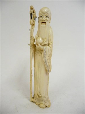 Lot 341 - A Japanese Carved Ivory Okimono, Meiji Period (1868-1912), as a standing figure with long beard and