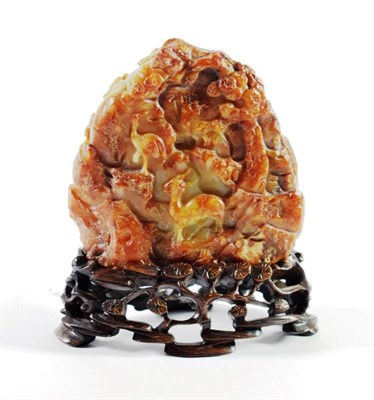 Lot 1426 - A Chinese Russet Jade Boulder, carved with a figure and a deer amongst trees, 8cm high