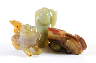 Lot 1429 - A Chinese Jade Figure of a Boy, holding a tree branch, 6cm; An Agate Figure of a Lion Dog, 5cm; and