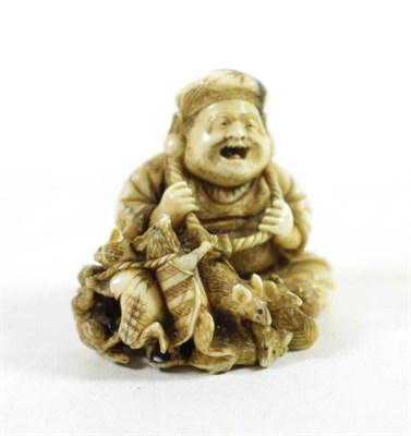 Lot 1445 - A Japanese Ivory Netsuke, Meiji period, in the form of Daikoku and five rats, signed to red lacquer