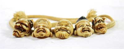 Lot 1446 - A Set of Japanese Ivory Netsukes, Meiji period, carved as Noh masks, each approximately 3cm high