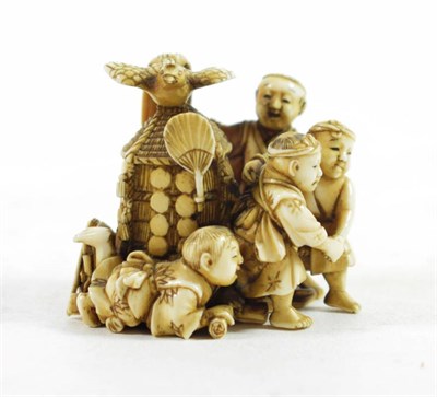 Lot 1451 - A Japanese Ivory Okimono, Meiji period, as four children and a dog  playing around a hut, a...