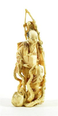 Lot 1452 - A Japanese Ivory Okimono, Meiji period, in the form of a fisherman with entwined octopus, 16cm high