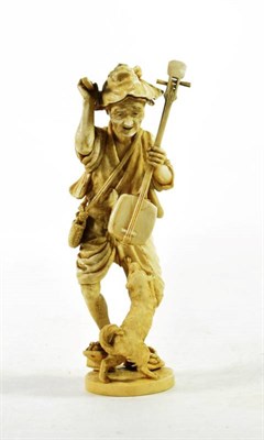 Lot 1458 - A Japanese Ivory Okimono, Meiji period, as an old a man holding a Biwa and plectrum, a dog at...