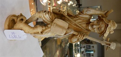 Lot 1458 - A Japanese Ivory Okimono, Meiji period, as an old a man holding a Biwa and plectrum, a dog at...