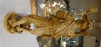 Lot 1458 - A Japanese Ivory Okimono, Meiji period, as an old a man holding a Biwa and plectrum, a dog at...