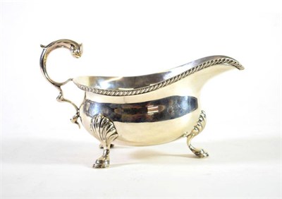 Lot 1485 - A George III Style Silver Sauce Boat, Mappin & Webb, London 1925, with flying leaf capped...