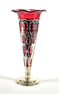 Lot 1553 - ~ An Edwardian Silver and Cranberry Glass Trumpet Vase, William Henry Sparrow, Birmingham 1906,...