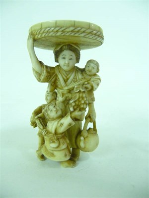 Lot 358 - A Japanese Carved Elephant Ivory Okimono, Meiji period (1868-1912), as a mother and three children