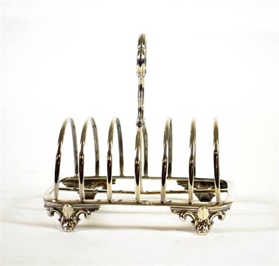 Lot 1619 - A Victorian Silver Toast Rack, Messrs Barnard, London 1850, rounded rectangular with scroll central