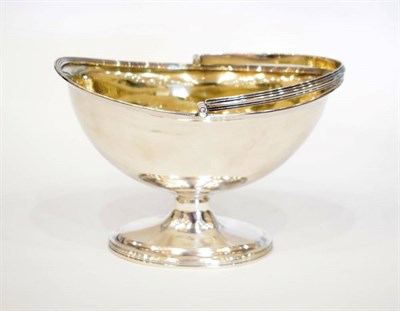 Lot 1621 - A George III Silver Swing Handled Sugar Basket, Henry Chawner, London 1796, plain boat form...