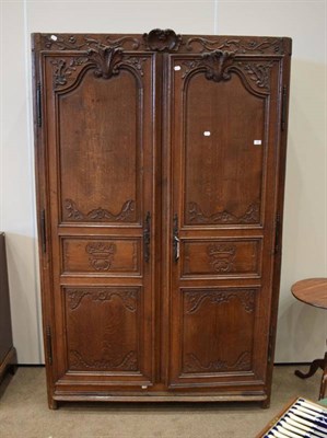 Lot 340 - A Late 18th/Early 19th Century French Carved Oak Armoire, the doors with six carved and moulded...