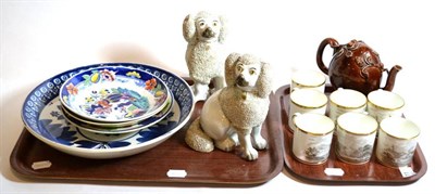 Lot 11 - A blue and white charger; seven Spode coffee cans; a pair of Staffordshire poodles; and a...