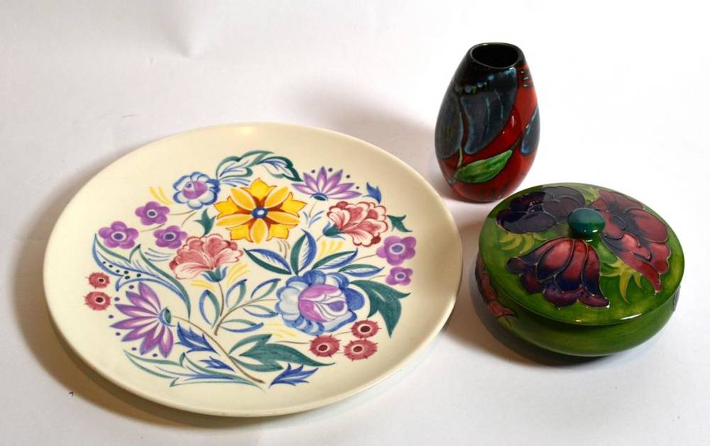 Lot 19 - A Moorcroft pottery circular dish and cover; a small Poole vase; and a Poole plate